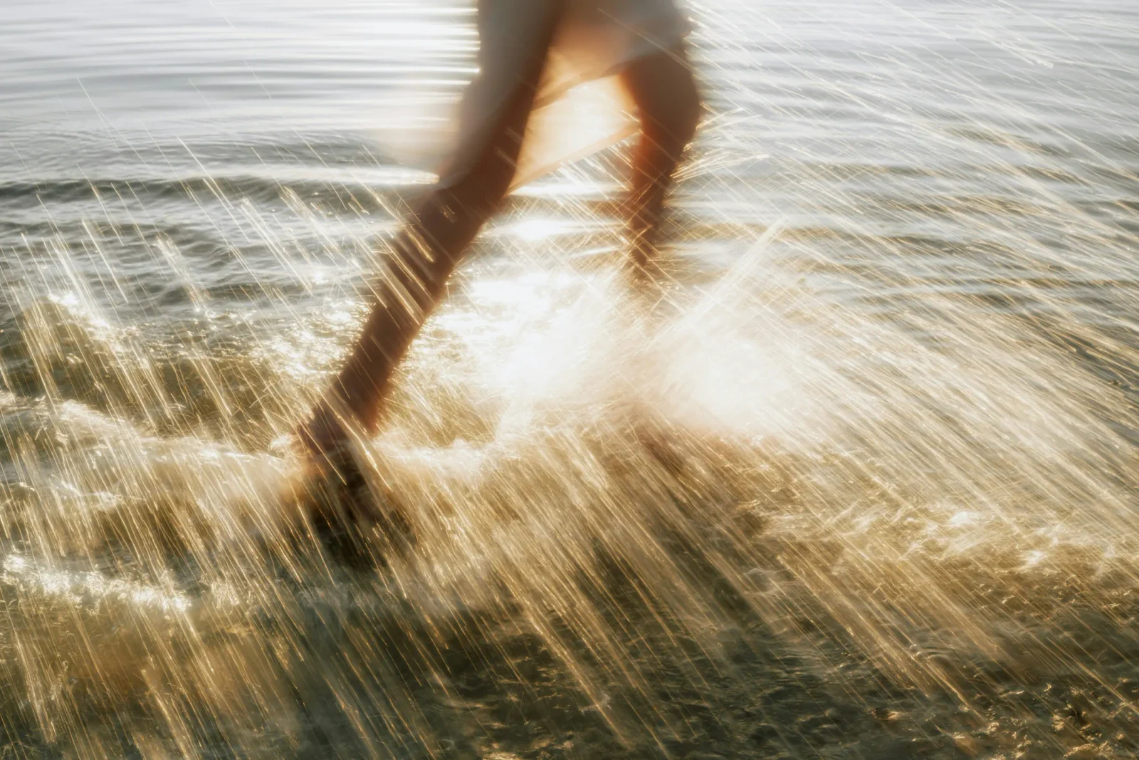 Sunlit water and a person moving through the shoreline, from the new Conociendo Libertad website